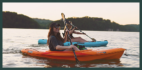 Two people paddling in canoes